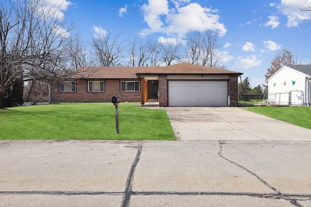 ranch-style home with a garage and a front lawn