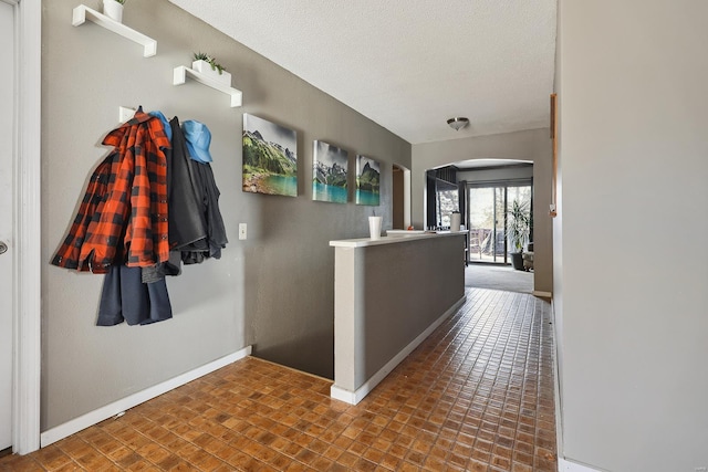 hall with a textured ceiling