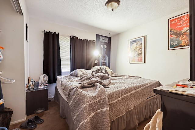 bedroom with a textured ceiling and carpet flooring