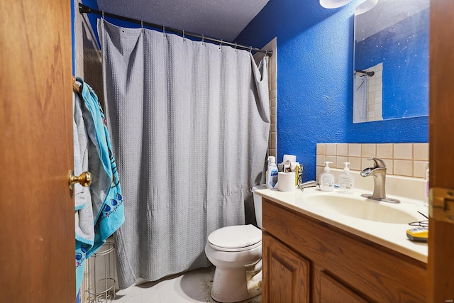 bathroom featuring vanity, curtained shower, a textured ceiling, and toilet