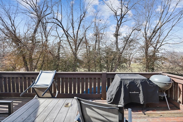 wooden terrace featuring a grill