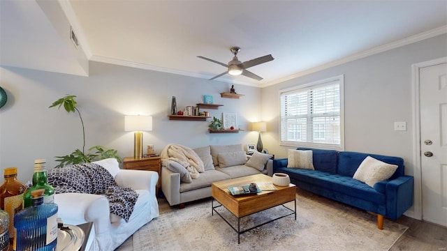 living room featuring ornamental molding, ceiling fan, and light wood-type flooring