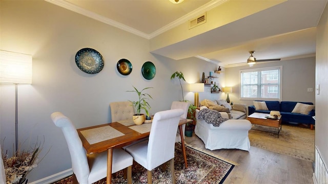 dining area with ornamental molding, hardwood / wood-style floors, and ceiling fan