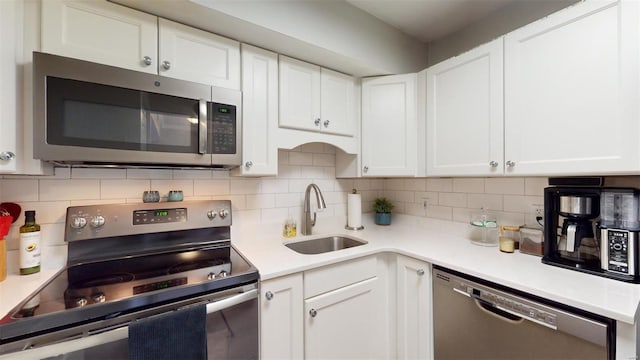 kitchen with white cabinetry, sink, and appliances with stainless steel finishes