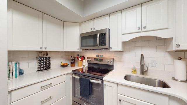 kitchen with white cabinetry and appliances with stainless steel finishes