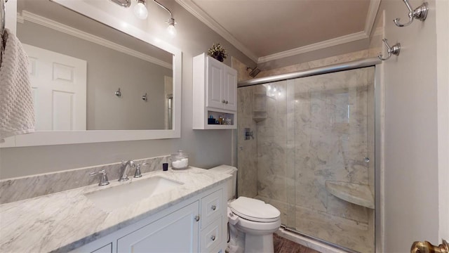 bathroom featuring crown molding, vanity, toilet, and a shower with door