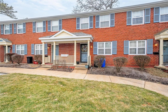 view of property with a porch and a front yard