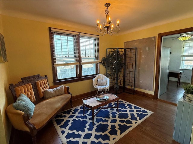 sitting room featuring a notable chandelier and dark hardwood / wood-style flooring