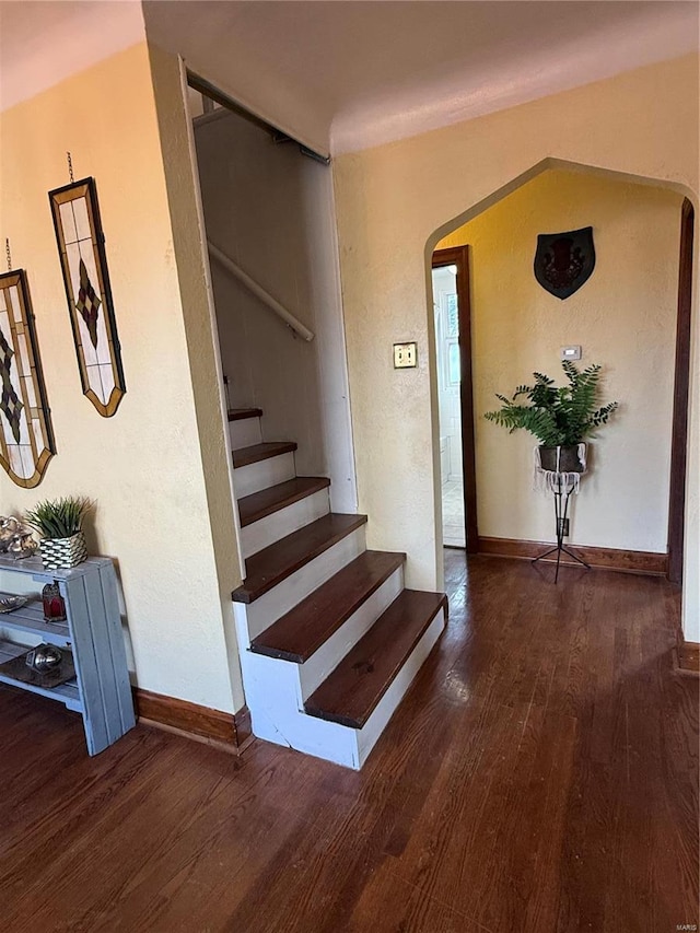 stairs featuring wood-type flooring