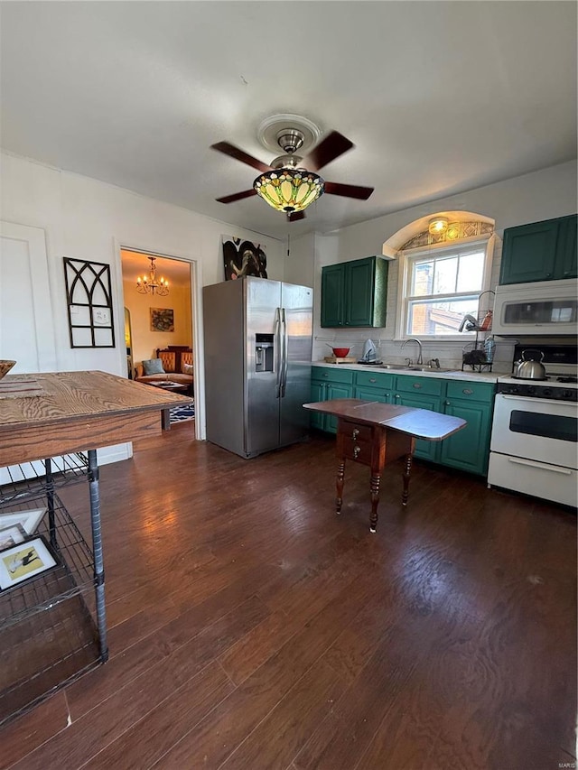 kitchen featuring white appliances, dark hardwood / wood-style flooring, sink, and green cabinets