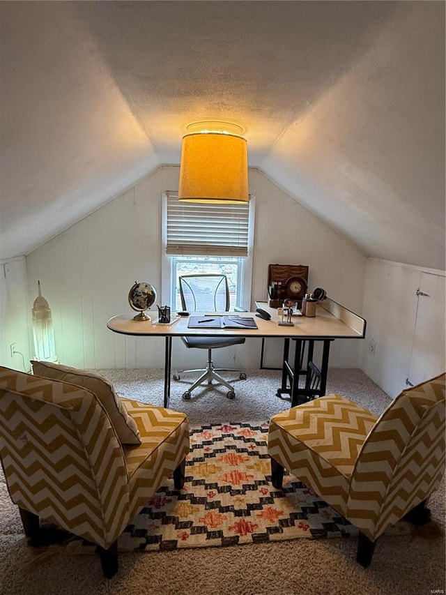 home office featuring vaulted ceiling, carpet, and a textured ceiling