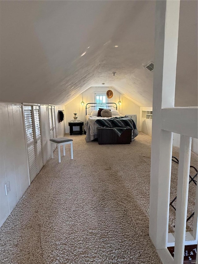 bedroom featuring lofted ceiling and carpet floors