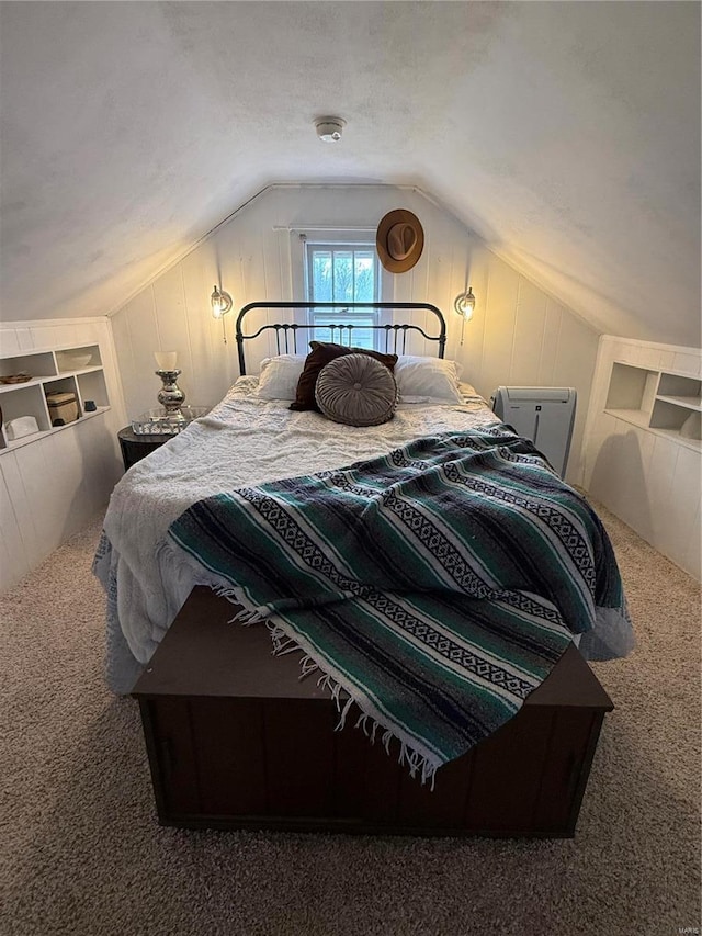 carpeted bedroom featuring vaulted ceiling and a textured ceiling