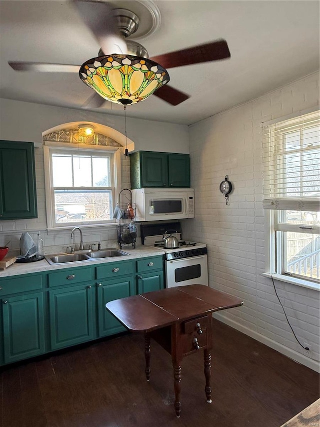 kitchen featuring a sink, white appliances, green cabinets, and dark wood-style flooring