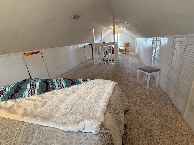 bedroom featuring lofted ceiling, carpet flooring, and visible vents