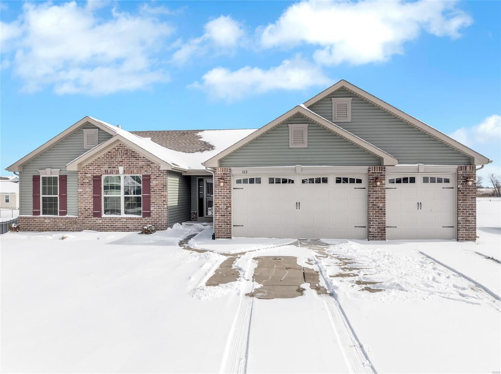 view of front of home featuring brick siding and an attached garage