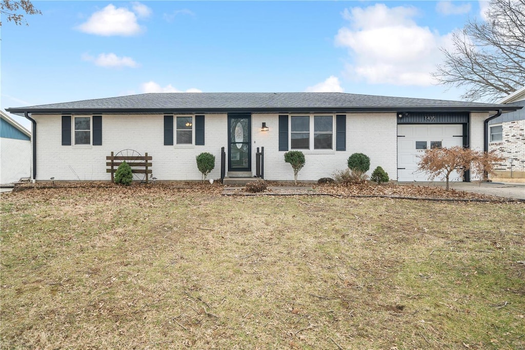 single story home featuring a garage and a front lawn