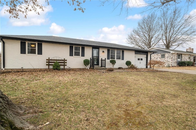 single story home with a garage and a front lawn