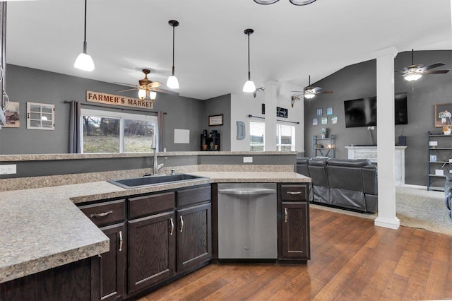 kitchen featuring pendant lighting, stainless steel dishwasher, dark brown cabinetry, and sink