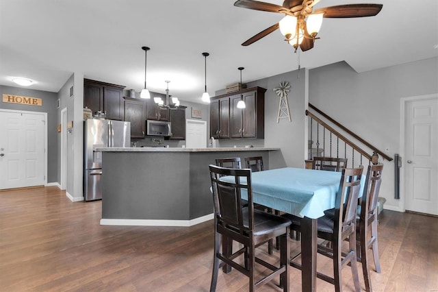 dining space with dark hardwood / wood-style floors and ceiling fan