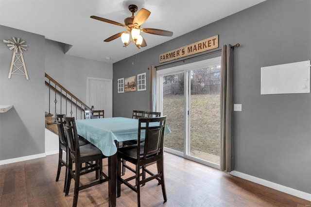 dining space featuring dark wood-type flooring and ceiling fan