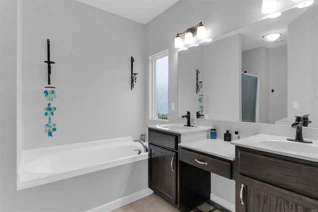 bathroom featuring vanity, tile patterned floors, and a bathing tub