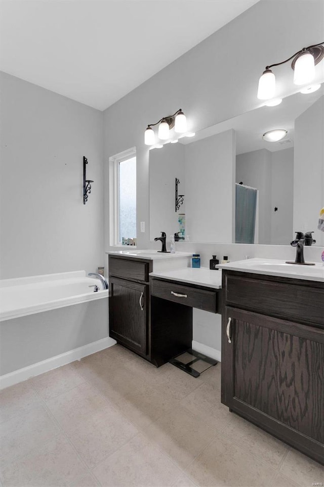 bathroom with vanity and a bath