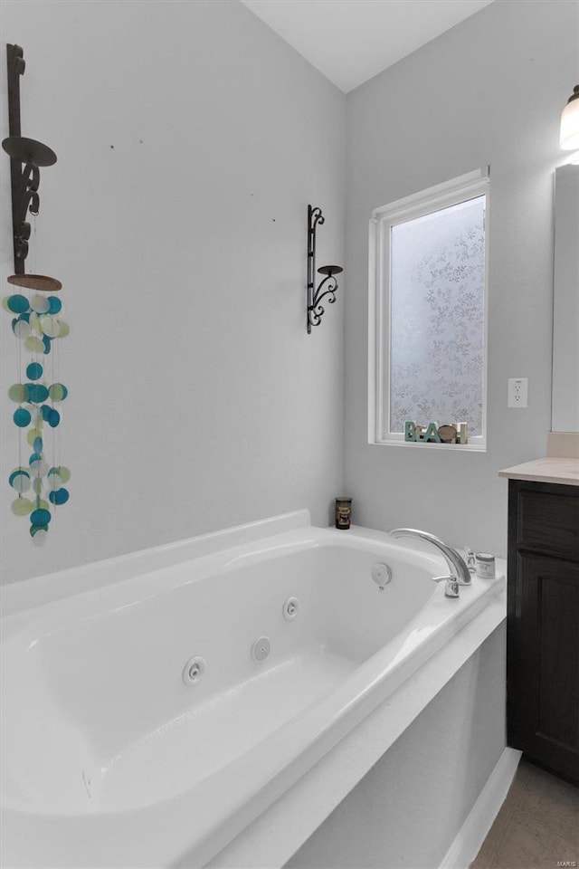 bathroom featuring vanity, a bath, and tile patterned floors