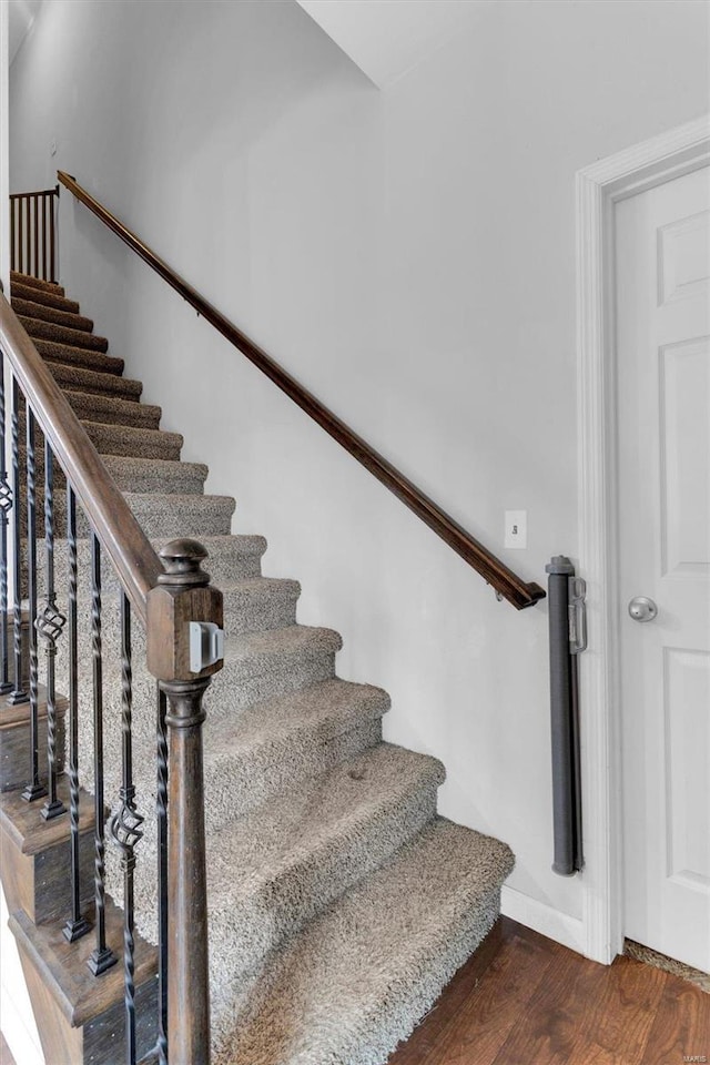 stairs featuring hardwood / wood-style floors