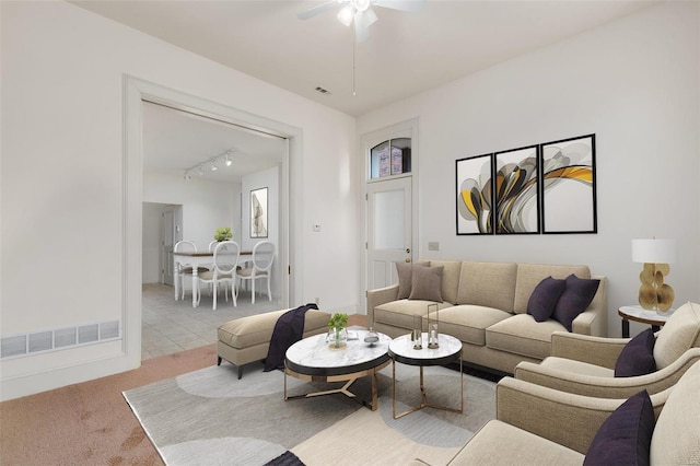 living room featuring visible vents, carpet floors, ceiling fan, and rail lighting