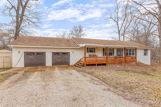 single story home with a porch and a garage