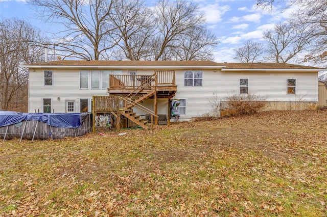 back of property featuring a pool side deck