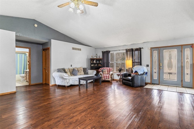 living room with lofted ceiling, ceiling fan, hardwood / wood-style flooring, and a textured ceiling