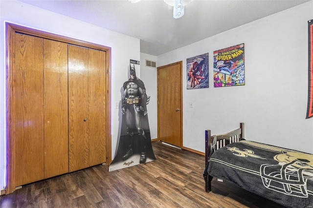 bedroom featuring dark wood-type flooring and a closet