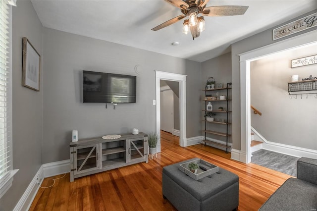 living room with hardwood / wood-style floors and ceiling fan