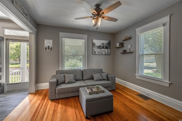 living room with hardwood / wood-style floors and ceiling fan