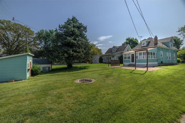 view of yard featuring a storage unit and a patio area