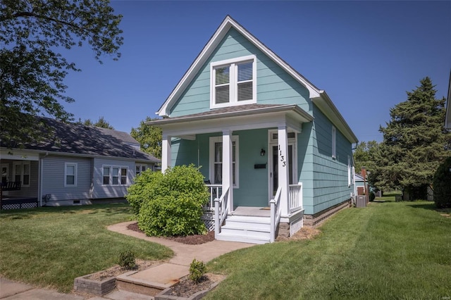 bungalow-style house with cooling unit and a front yard