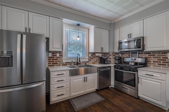 kitchen featuring tasteful backsplash, sink, white cabinets, dark hardwood / wood-style flooring, and stainless steel appliances