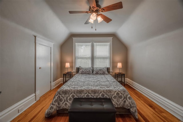 bedroom featuring ceiling fan, wood-type flooring, and vaulted ceiling