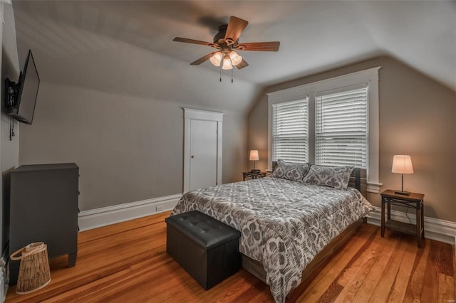 bedroom with wood-type flooring, vaulted ceiling, and ceiling fan