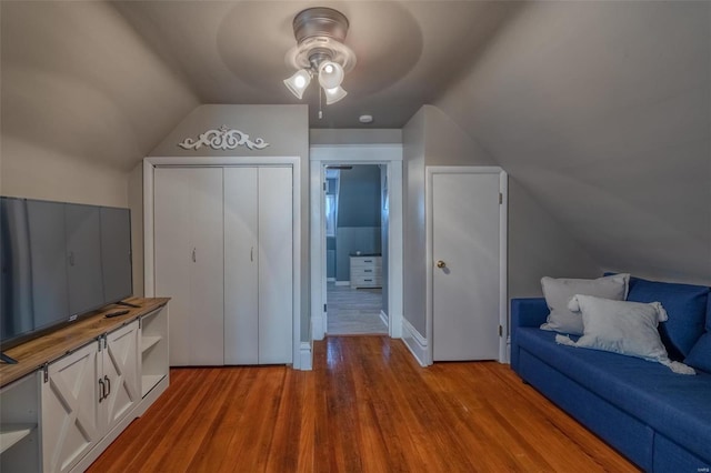 interior space featuring lofted ceiling, hardwood / wood-style flooring, and ceiling fan