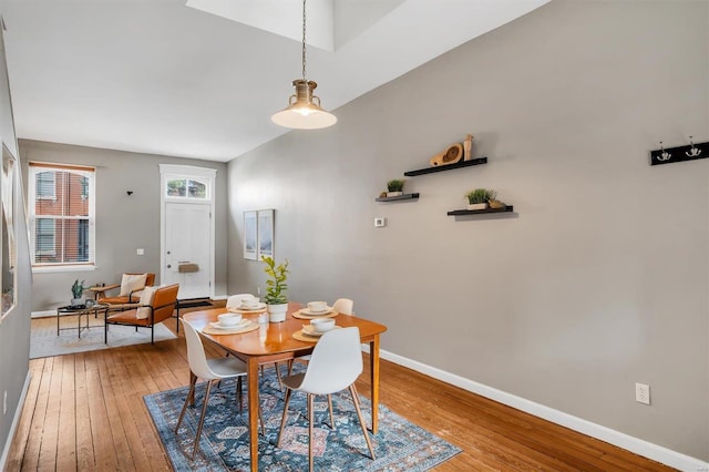 dining space with light wood-style flooring and baseboards