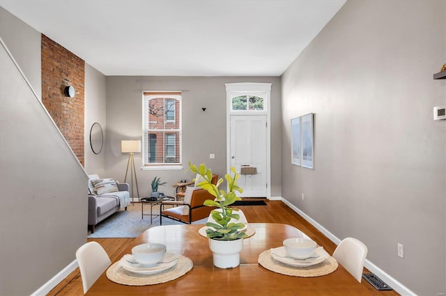 dining area featuring baseboards and wood finished floors