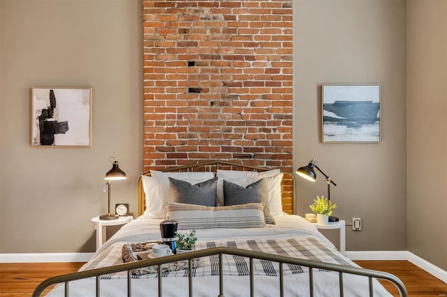 bedroom featuring wood finished floors and baseboards