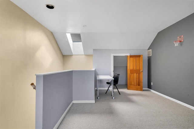 interior space featuring vaulted ceiling, visible vents, and baseboards