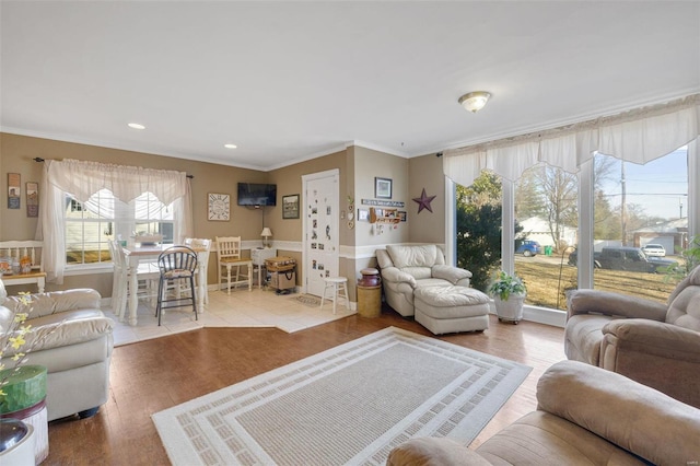 living room featuring ornamental molding and light wood-type flooring