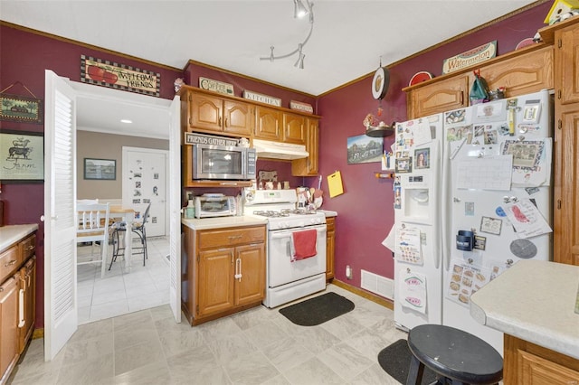 kitchen with white appliances and rail lighting