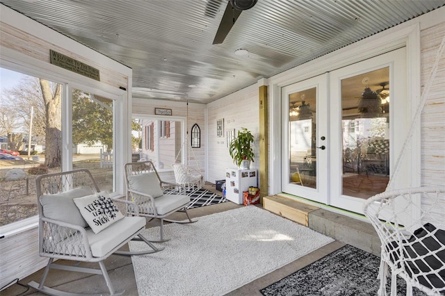 sunroom / solarium with ceiling fan and french doors