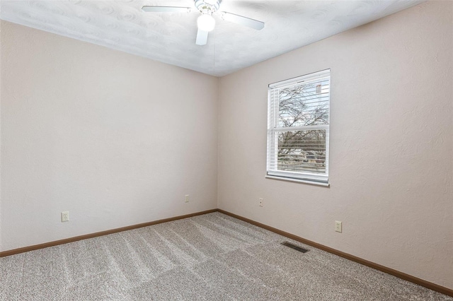 carpeted empty room with ceiling fan